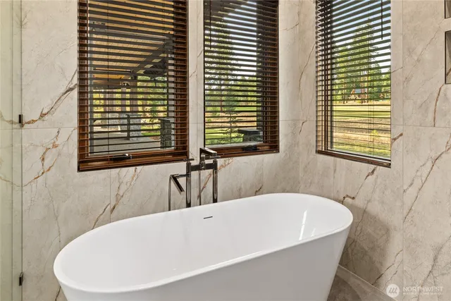 a bathroom with a bathtub and a window