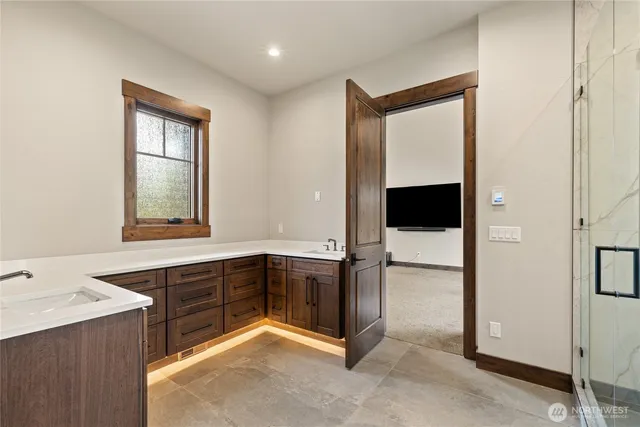 a bathroom with a tub mirror and sink
