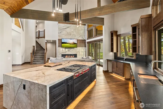 a kitchen with a stove and a wooden floor
