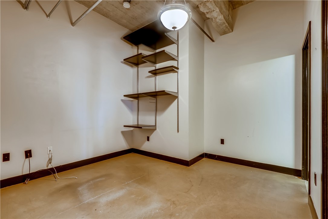 710 Colorado Street, Unit 4J Austin, TX 78701 - Photo 22 of 37 Built in shelves in downstairs bedroom