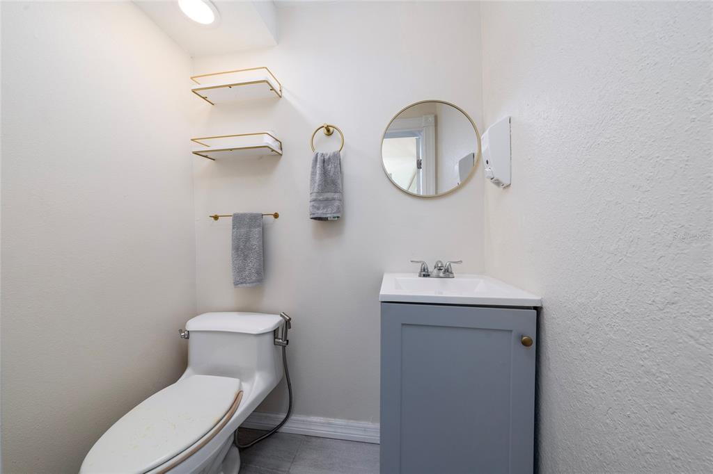 357 Ridgewood Street Altamonte Springs, FL 32701 - Photo 10 of 36 a bathroom with a toilet a sink and mirror