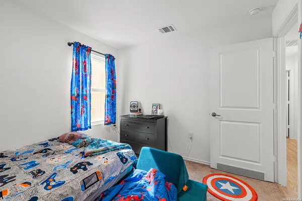 a bedroom with a bed and a dresser in it