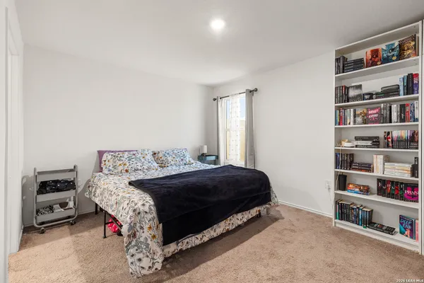a bedroom with a bed and a book shelf