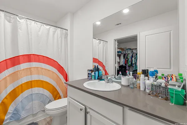 a bathroom with a sink a mirror and a toilet