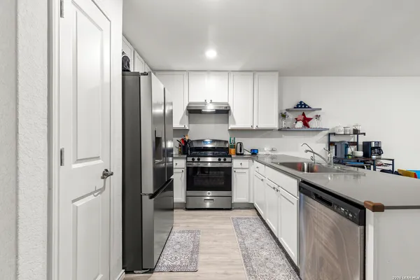 a kitchen with a stove and a refrigerator