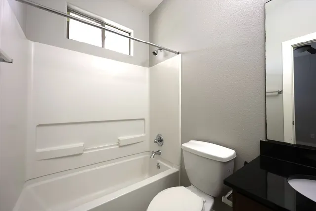 a bathroom with a toilet a sink and a shower