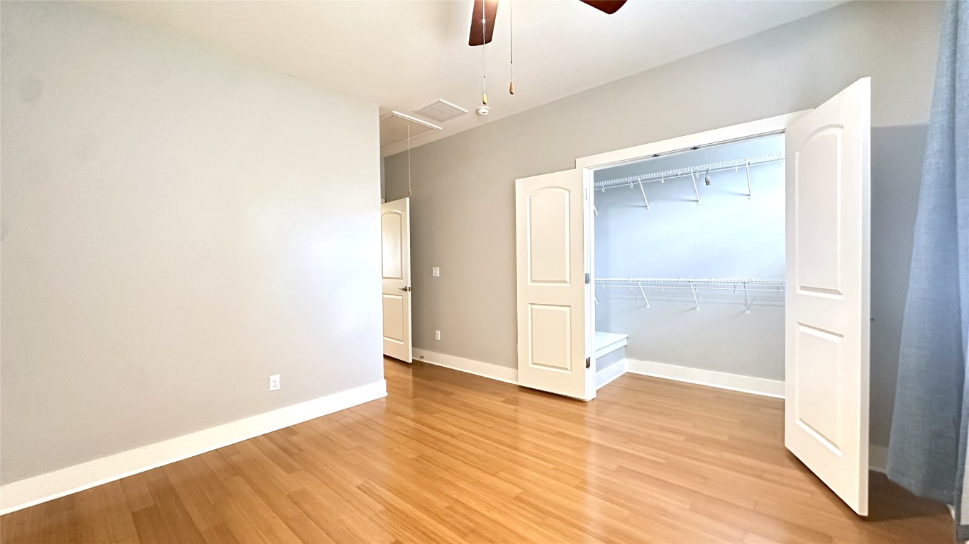 13420 Lyndhurst Street, Unit 304 Austin, TX 78717 - Photo 8 of 17 a view of an empty room with wooden floor
