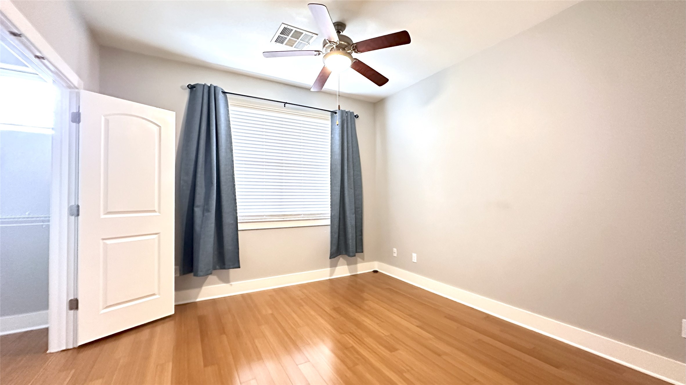 13420 Lyndhurst Street, Unit 304 Austin, TX 78717 - Photo 9 of 17 a view of empty room with wooden floor and fan
