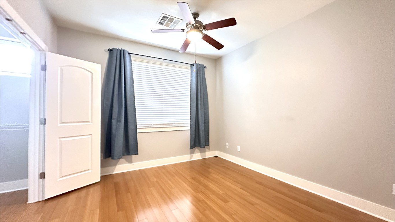13420 Lyndhurst Street, Unit 304 Austin, TX 78717 - Photo 9 of 17 a view of empty room with wooden floor and fan