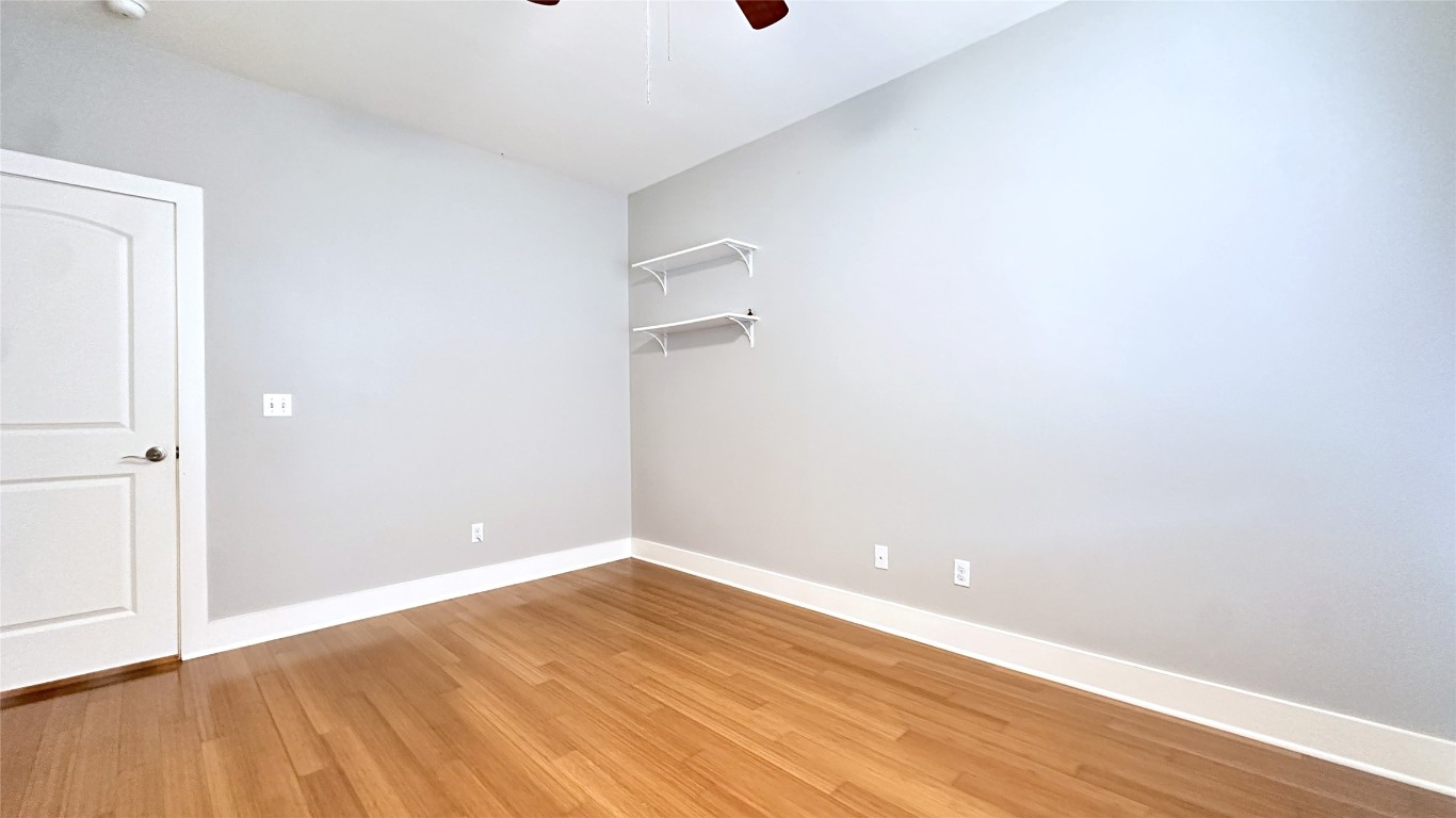 13420 Lyndhurst Street, Unit 304 Austin, TX 78717 - Photo 10 of 17 a view of an empty room with wooden floor