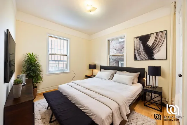 a bedroom with a bed and a painting on the wall