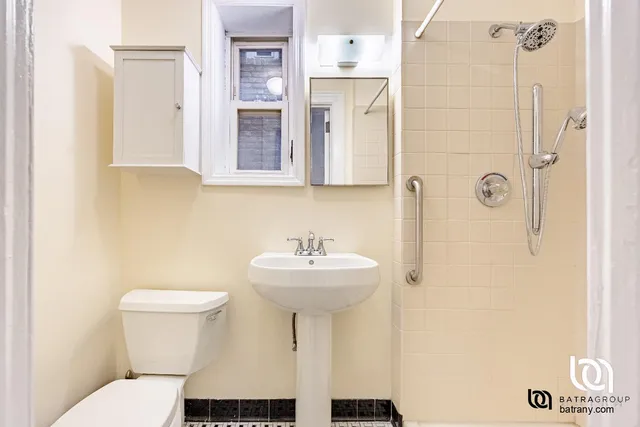 a bathroom with a sink toilet and mirror