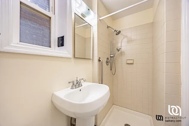 a bathroom with a sink a mirror and a shower