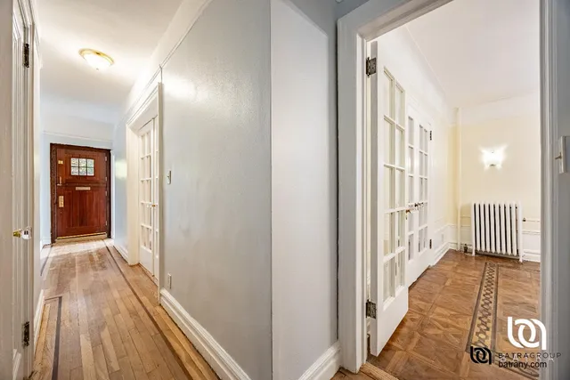 a view of a hallway with wooden floor