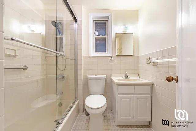 a bathroom with a toilet sink and shower