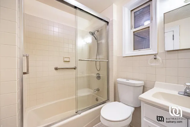 a white toilet sitting next to a bath tub shower