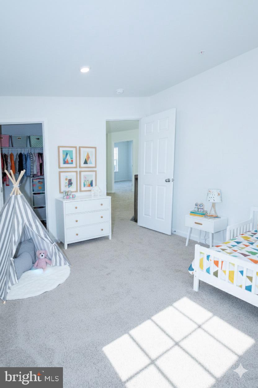 1817 Colt Lane Frederick, MD 21702 - Photo 18 of 43 a room with a baby bed and a couch