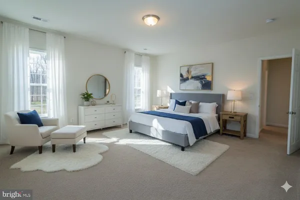 a spacious bedroom with a bed and a couch