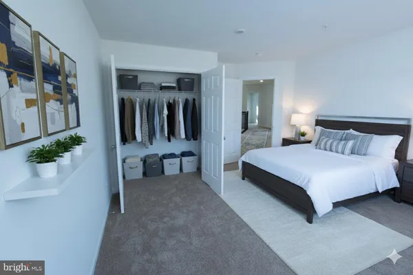 a bedroom with a bed and potted plant