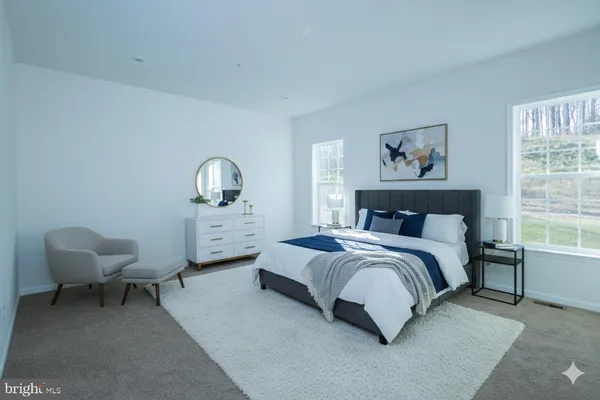 a hall way with furniture a mirror and a window