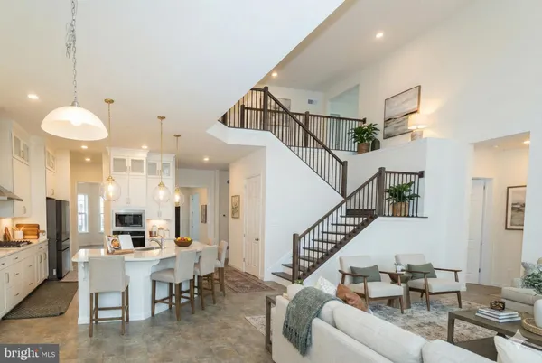 a living room with lots of furniture and a chandelier