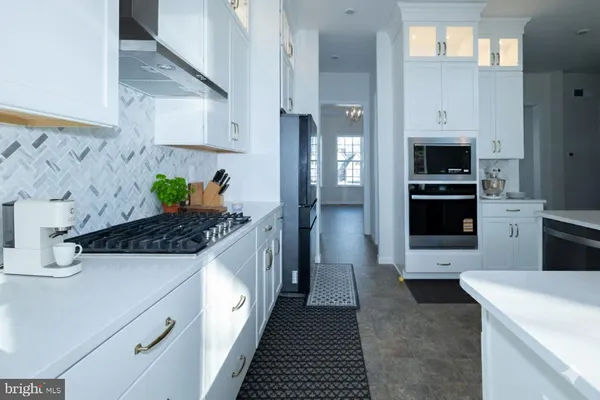 a kitchen with stainless steel appliances a stove and a refrigerator