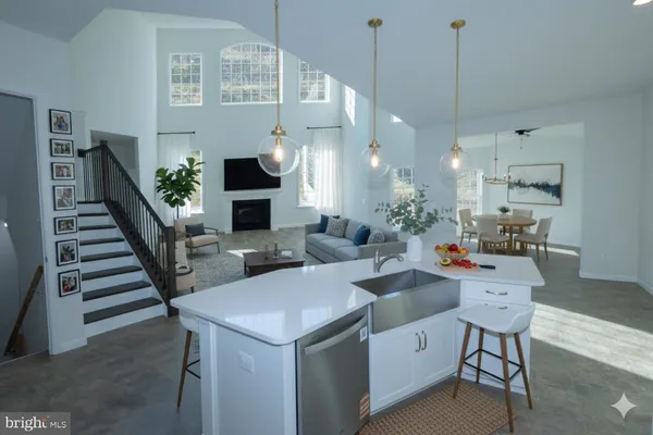 a living room with furniture a fireplace and wooden floor