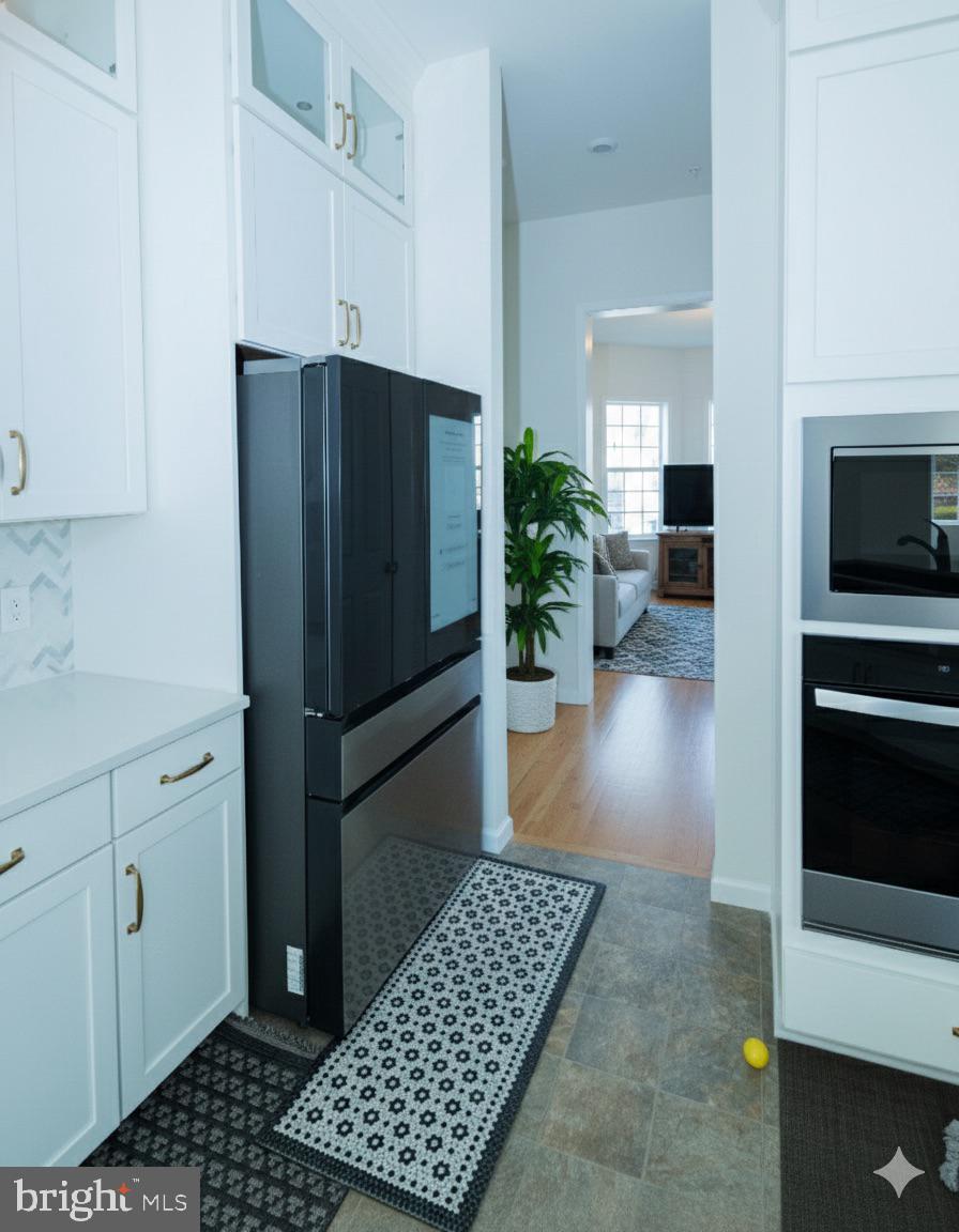 1817 Colt Lane Frederick, MD 21702 - Photo 8 of 43 a kitchen with stainless steel appliances a refrigerator and a counter top space