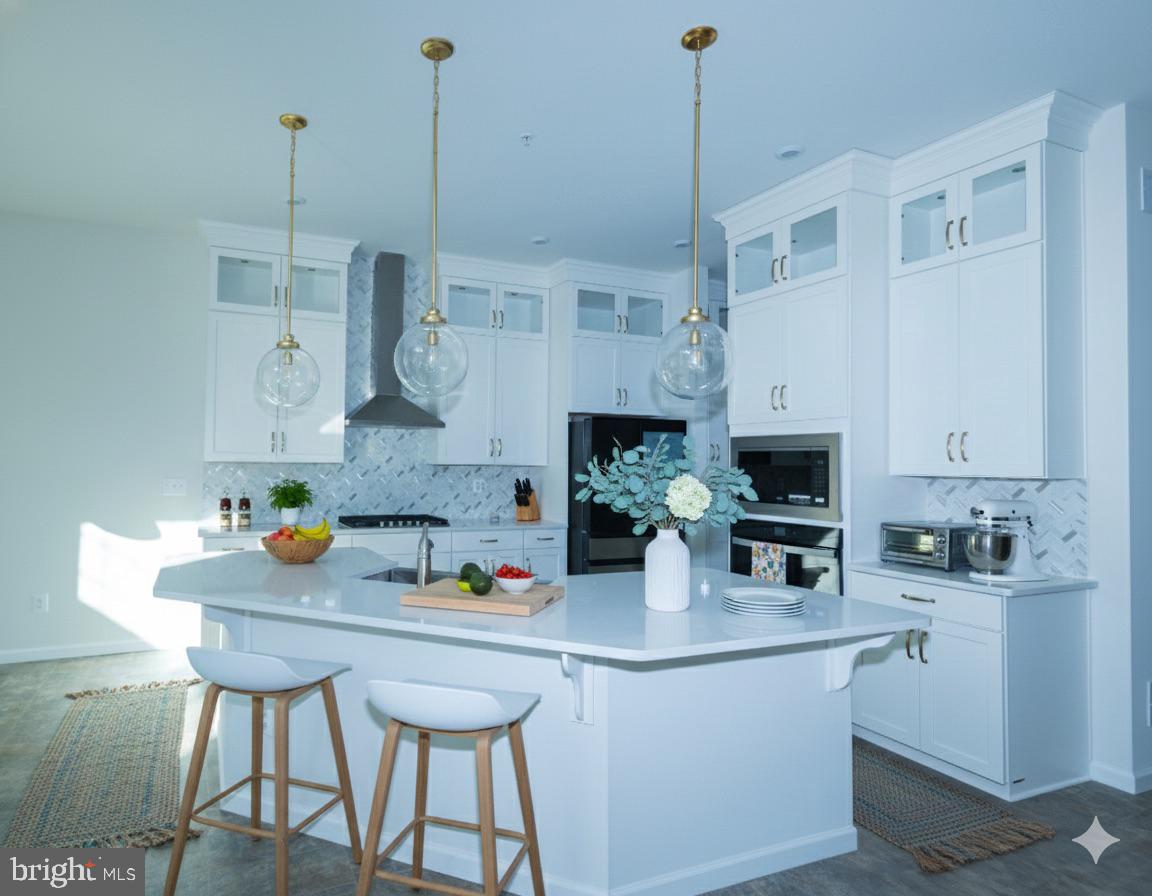 1817 Colt Lane Frederick, MD 21702 - Photo 9 of 43 a kitchen with stainless steel appliances a sink a white cabinets and chairs
