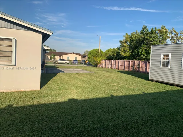 a swimming pool with an outdoor space and seating area