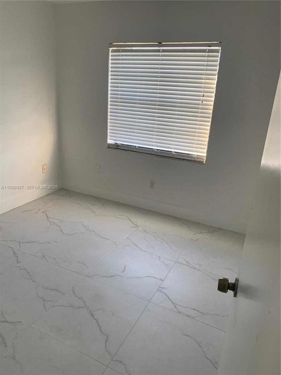14301 Southwest 105th Avenue Miami, FL 33176 - Photo 6 of 15 an empty room with a window