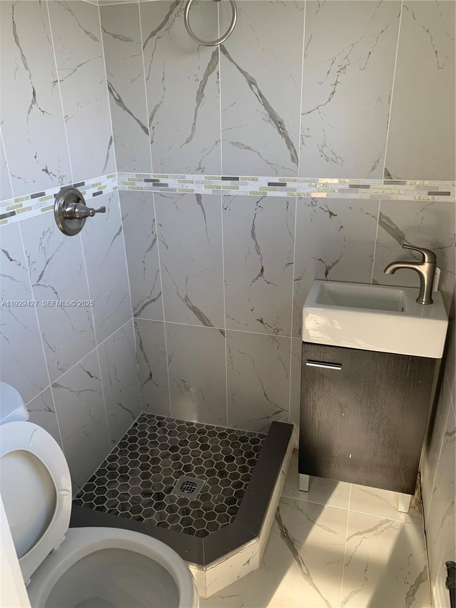14301 Southwest 105th Avenue Miami, FL 33176 - Photo 9 of 15 a bathroom with a sink toilet and shower