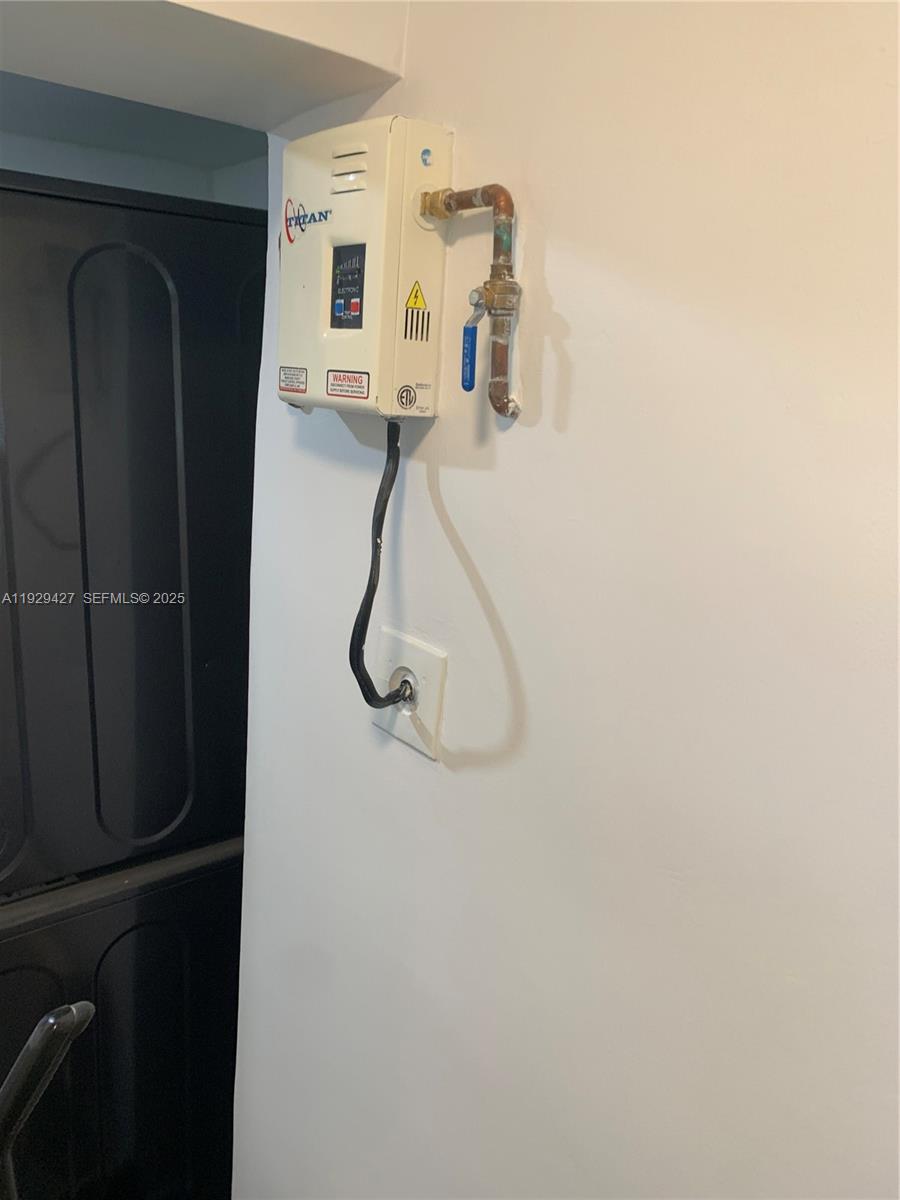 14301 Southwest 105th Avenue Miami, FL 33176 - Photo 10 of 15 a room with a refrigerator and mirror