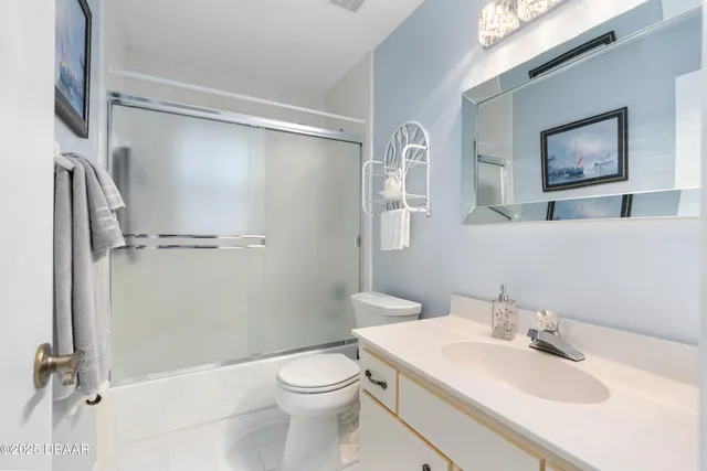 a bathroom with a white toilet sitting next to a bathroom sink