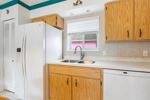 a kitchen with stainless steel appliances a refrigerator sink and cabinets