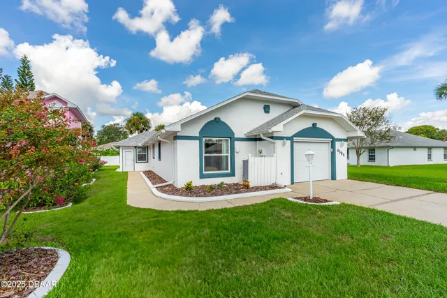a view of backyard with swimming pool and outdoor seating