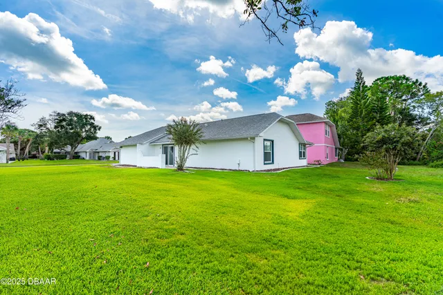 a front view of house with yard and green space