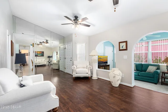 a living room with furniture and a wooden floor