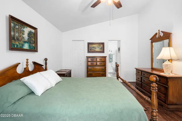 a bedroom with furniture and a lamp