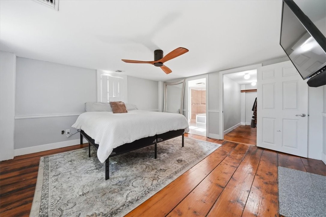 32 Equestrian Way Cranston, RI 02921 - Photo 18 of 50 The primary bedroom offers an impressive private sanctuary on the second floor, complete with beautifully aged wide-plank flooring, its own fireplace, a substantial walk-in closet and a bright ensuite bath. The result is a suite that feels both timeless and highly functional.