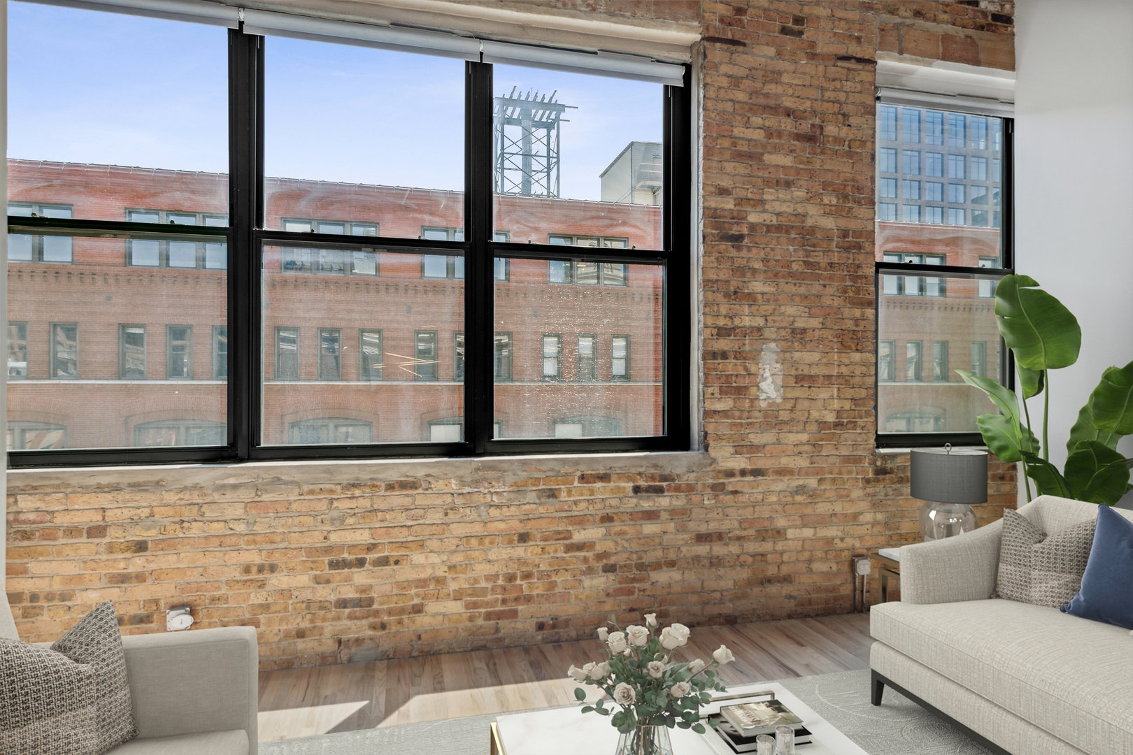 1000 West Washington Boulevard, Unit 513 Chicago, IL 60607 - Photo 8 of 22 a living room with couches a coffee table and a large window with garden view