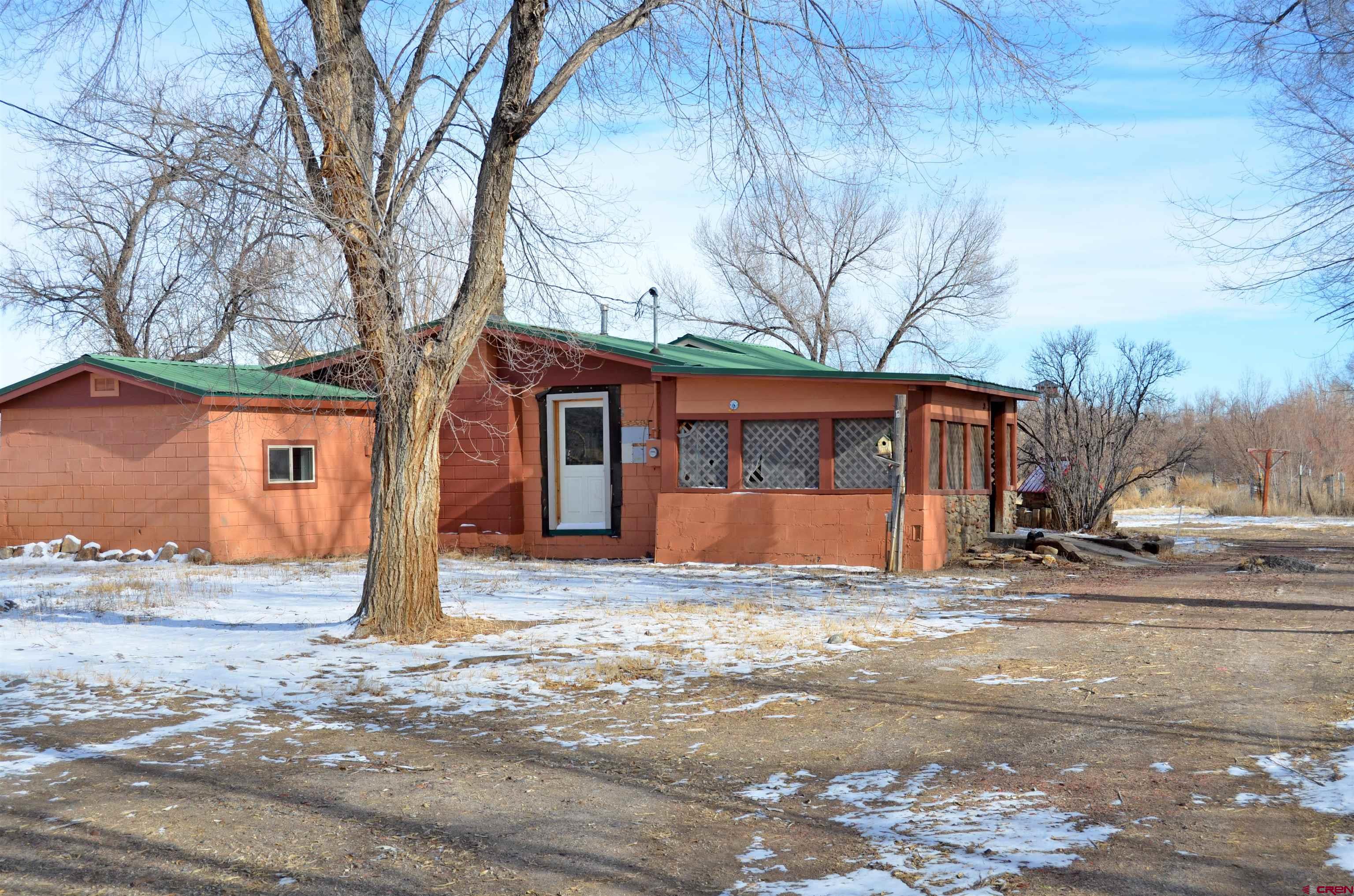 a view of a house with a yard and tree
