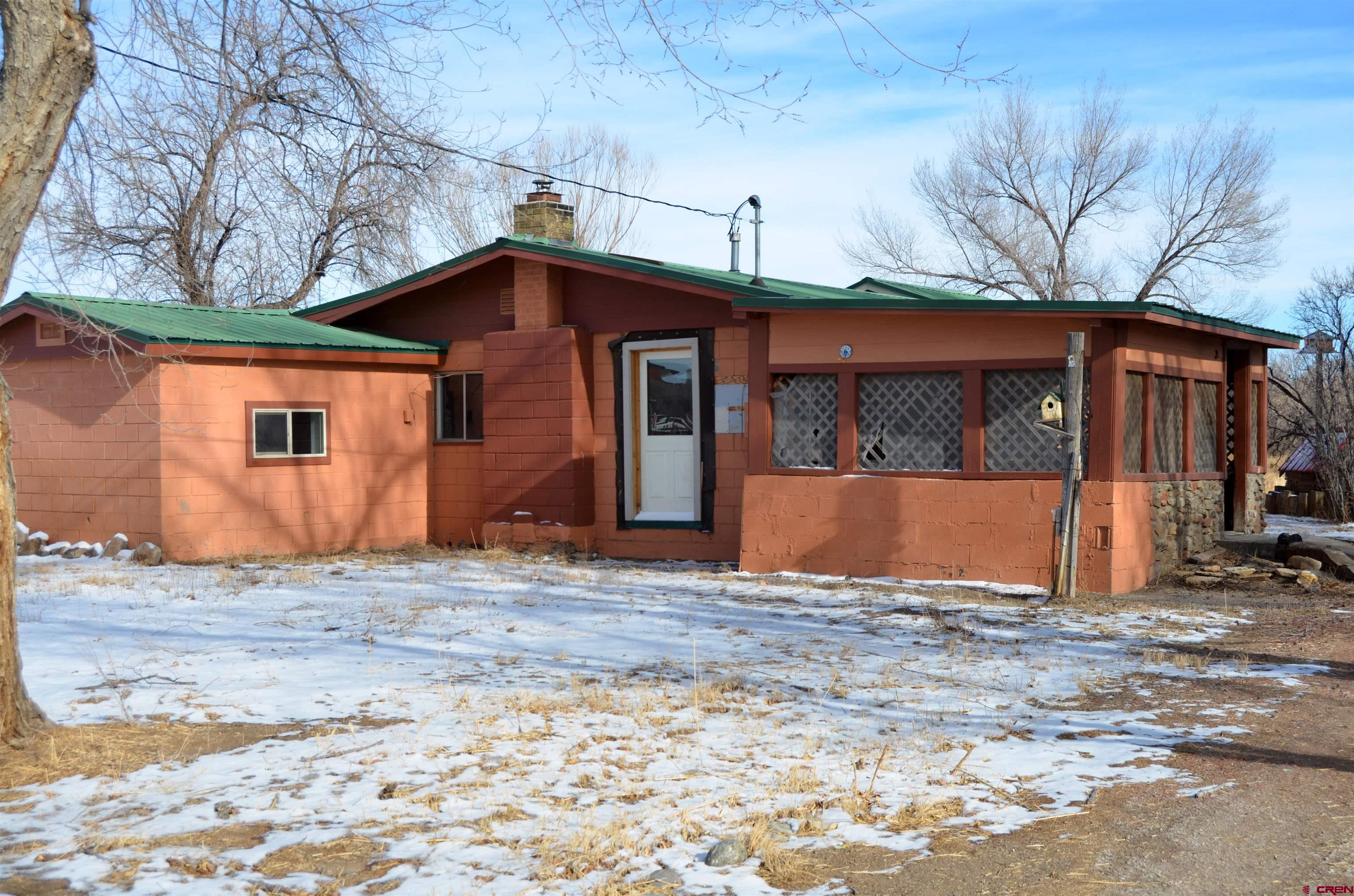 6088 Graff Road Delta, CO 81416 - Photo 3 of 16 a house with trees in the background