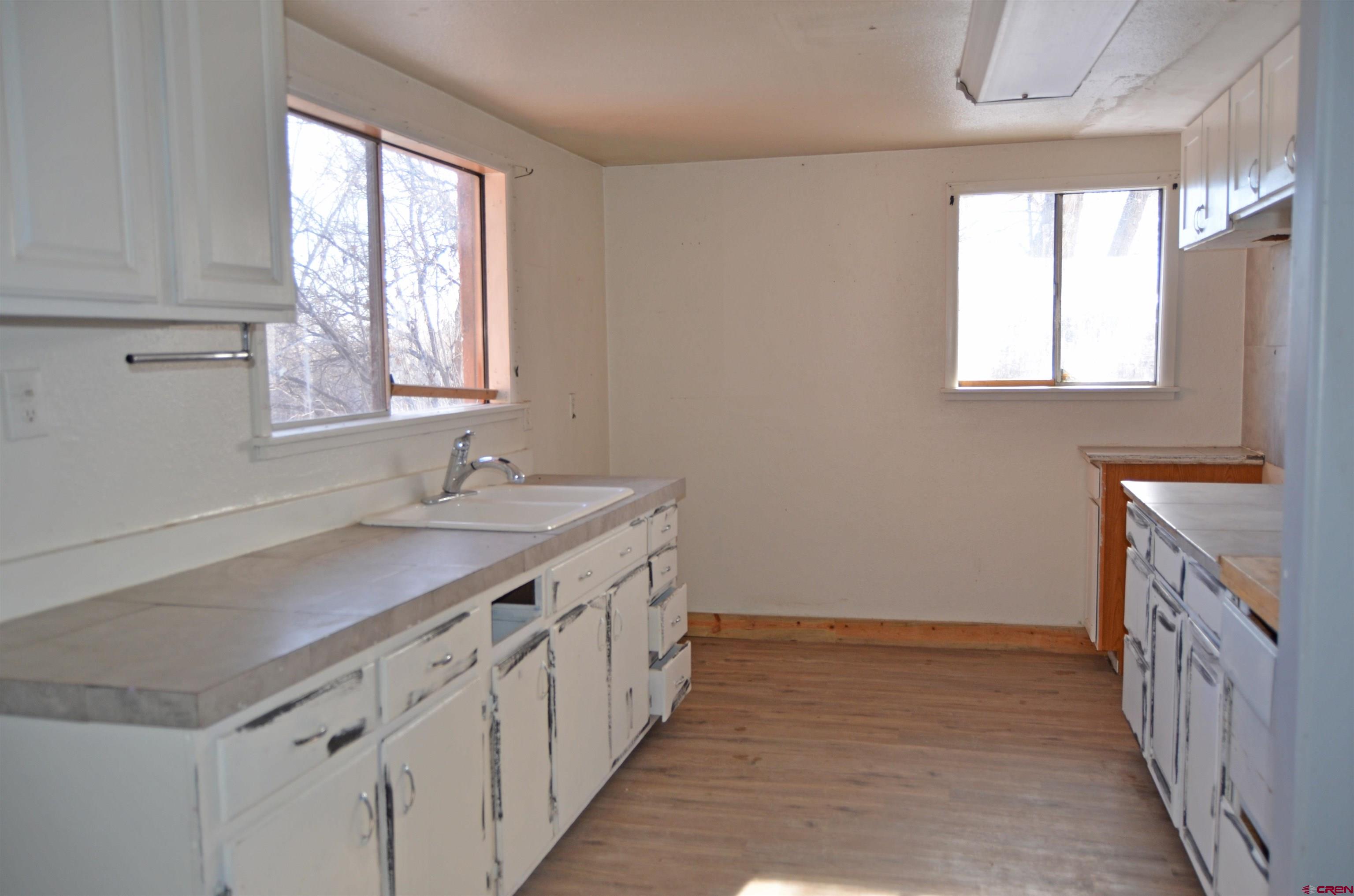 6088 Graff Road Delta, CO 81416 - Photo 6 of 16 a bathroom with a sink a mirror and a window