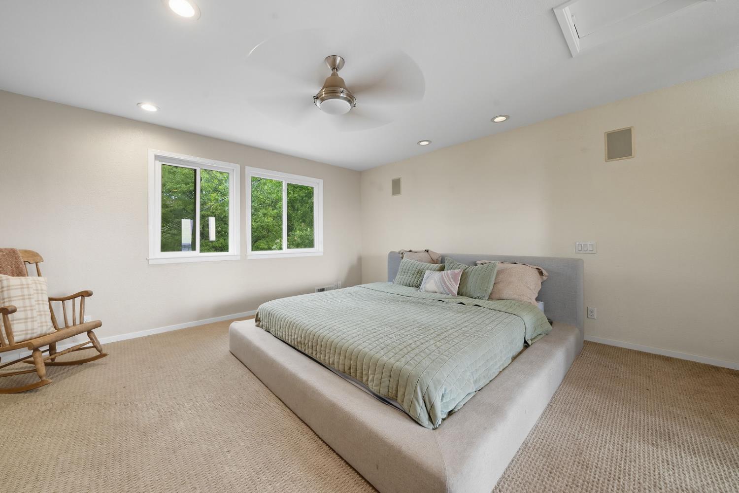 10285 Ponderosa Way Jackson, CA 95642 - Photo 34 of 84 a spacious bedroom with a large bed and a chandelier
