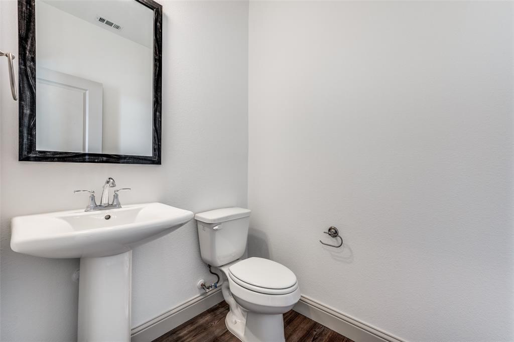 15866 Yellow Elder Road Frisco, TX 75035 - Photo 14 of 25 a bathroom with a toilet sink and mirror