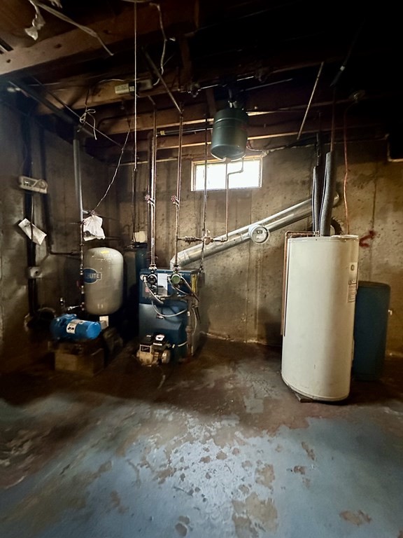 76 Americo Street Ludlow, MA 01056 - Photo 18 of 21 a room with water heater and wooden cabinets