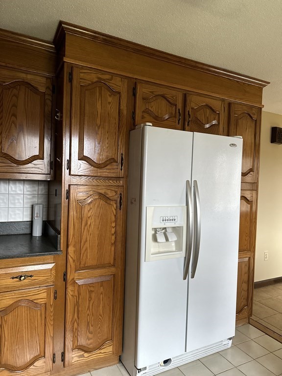 76 Americo Street Ludlow, MA 01056 - Photo 5 of 21 a metallic refrigerator freezer sitting in a kitchen