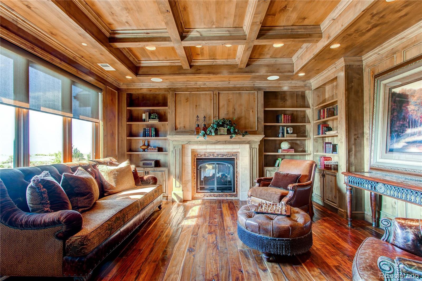 5764 Amber Ridge Drive Castle Pines, CO 80108 - Photo 11 of 50 a living room with furniture and a fireplace
