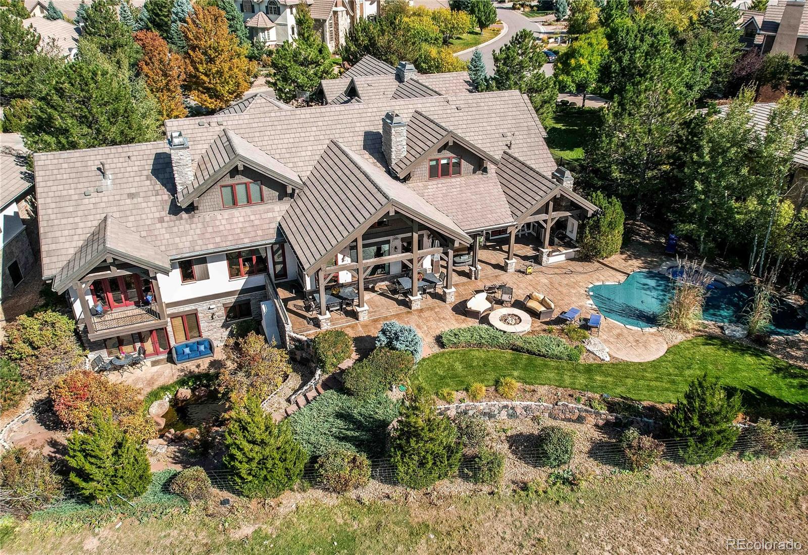 5764 Amber Ridge Drive Castle Pines, CO 80108 - Photo 2 of 50 an aerial view of multiple houses with yard